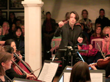 orchestra performing inside a hall