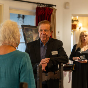 Artist Rick J. Delanty talking to a guest inside The Studio at Casa Romantica