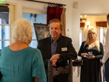 Artist Rick J. Delanty talking to a guest inside The Studio at Casa Romantica