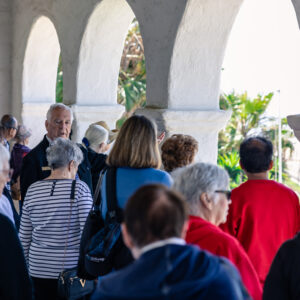 Volunteer leading a group tour around Casa Romantica