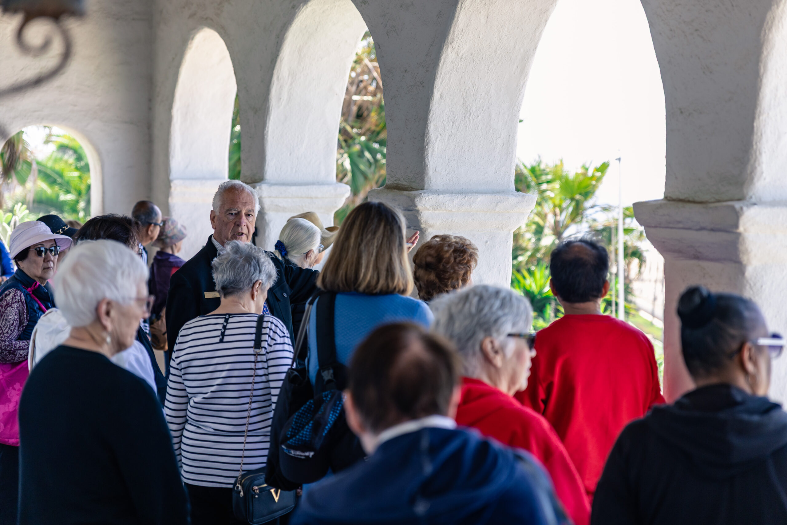 Volunteer leading a group tour around Casa Romantica