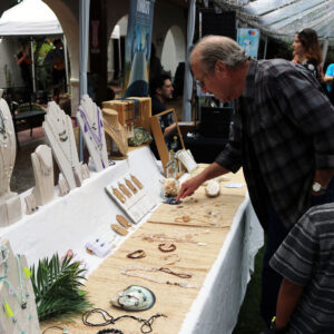 Guests viewing items available for purchase from an artist vendor