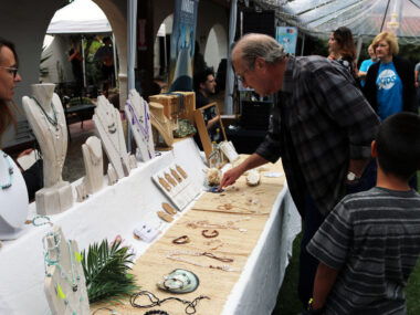 Guests viewing items available for purchase from an artist vendor