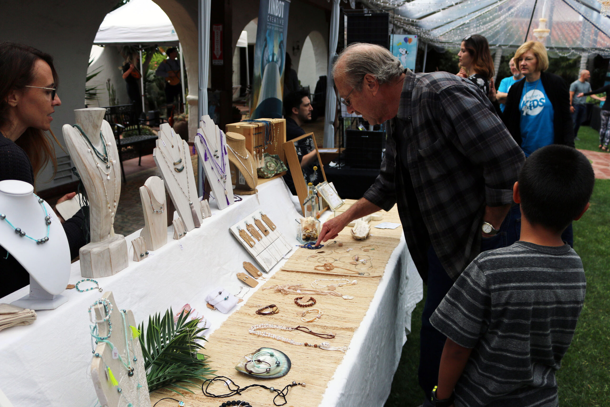 Guests viewing items available for purchase from an artist vendor