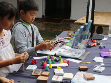 Kids assembling crafts on a table