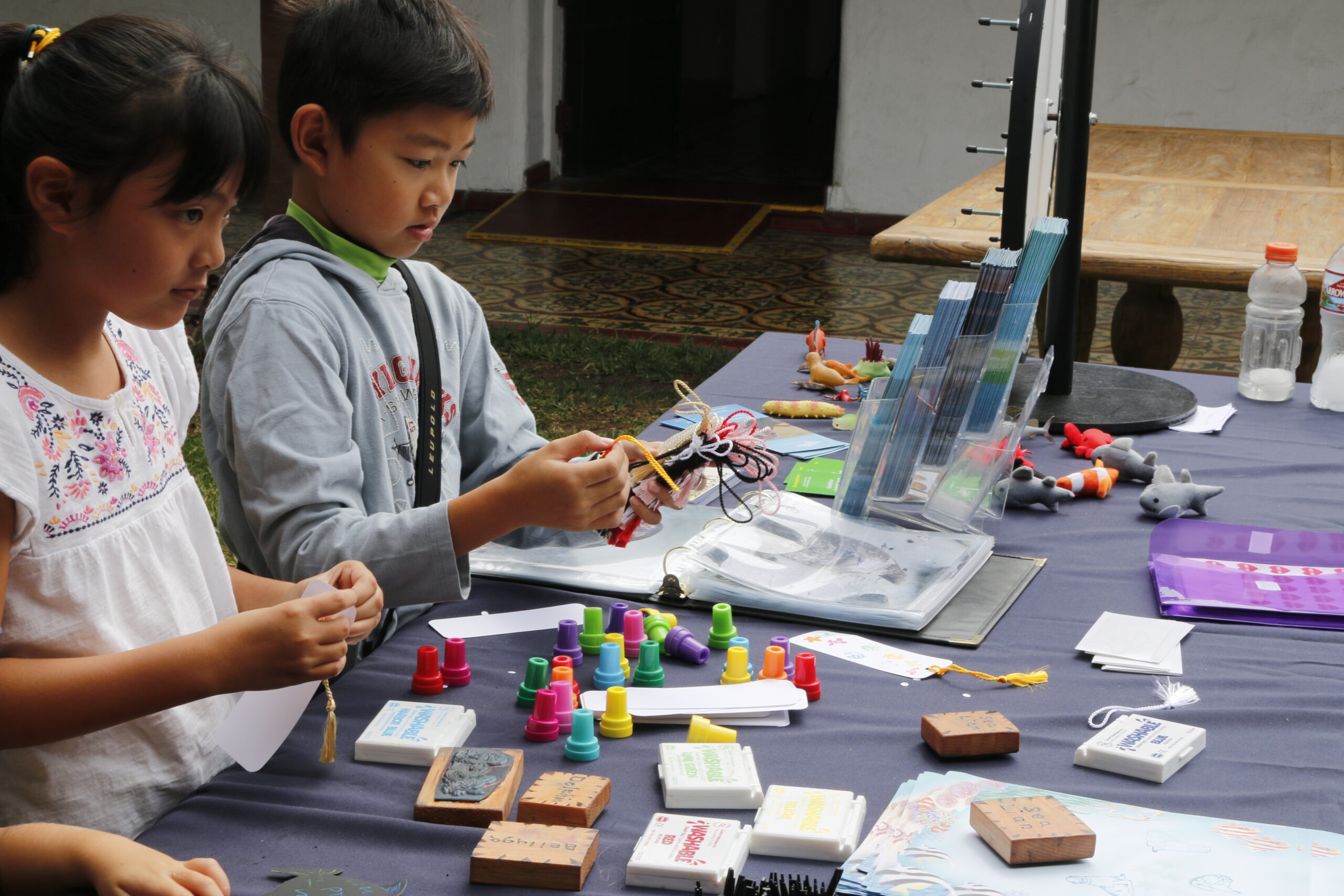 Kids assembling crafts on a table