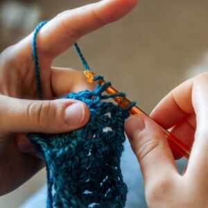 Person crocheting yarn