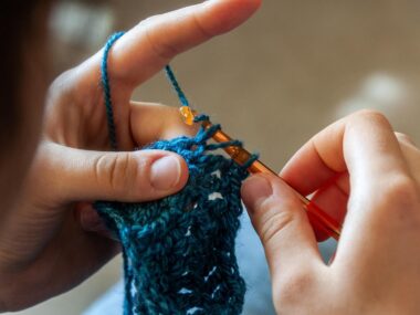 Person crocheting yarn