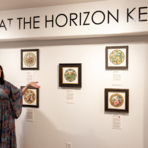 Artist Judith Haron poses with her art exhibition in the Gallery